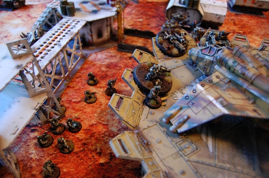 The infantry squad and the 2IC leave the safety of the guard tower and advance ahead to reinforce the Elysian positions around the first objective marker on the landing pad. Using the order 'Get back into the fight!' Cpt. Perseus orders the heavy weapons to open fire on the Spiritseer after disengaging. All shots fail to hit however.